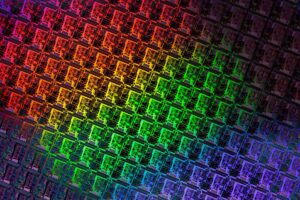 Close-up of a patterned silicon wafer with color gradients.