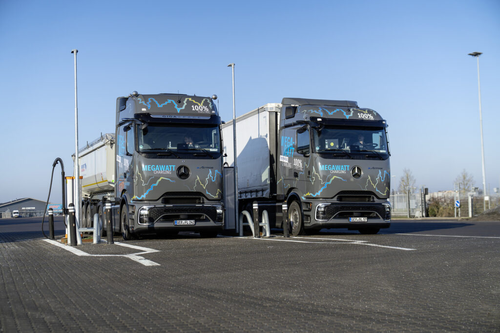 Two Mercedes-Benz eActros 600 electric test trucks at a charging site during the January 2026 Megawatt Charging System test program.