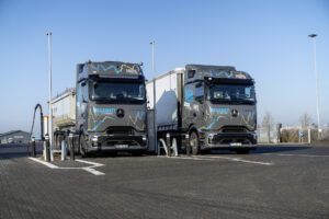 Two Mercedes-Benz eActros 600 electric test trucks at a charging site during the January 2026 Megawatt Charging System test program.