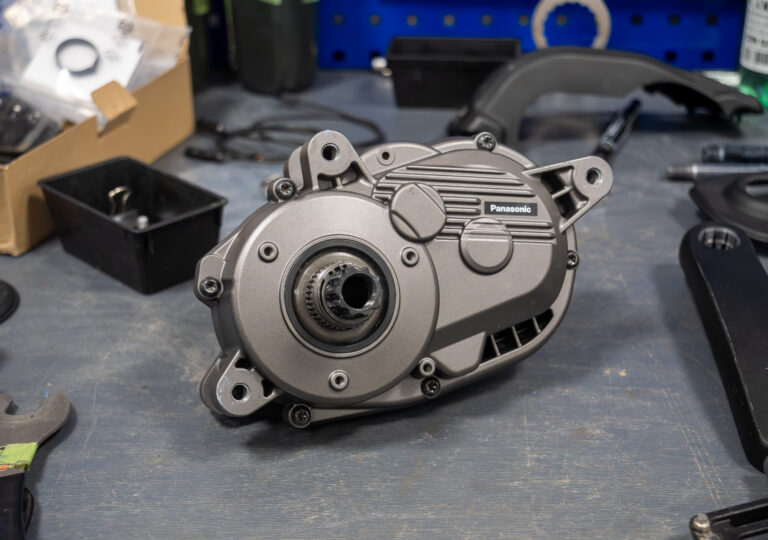 Prototype mid-mounted pedelec motor on a workbench.
