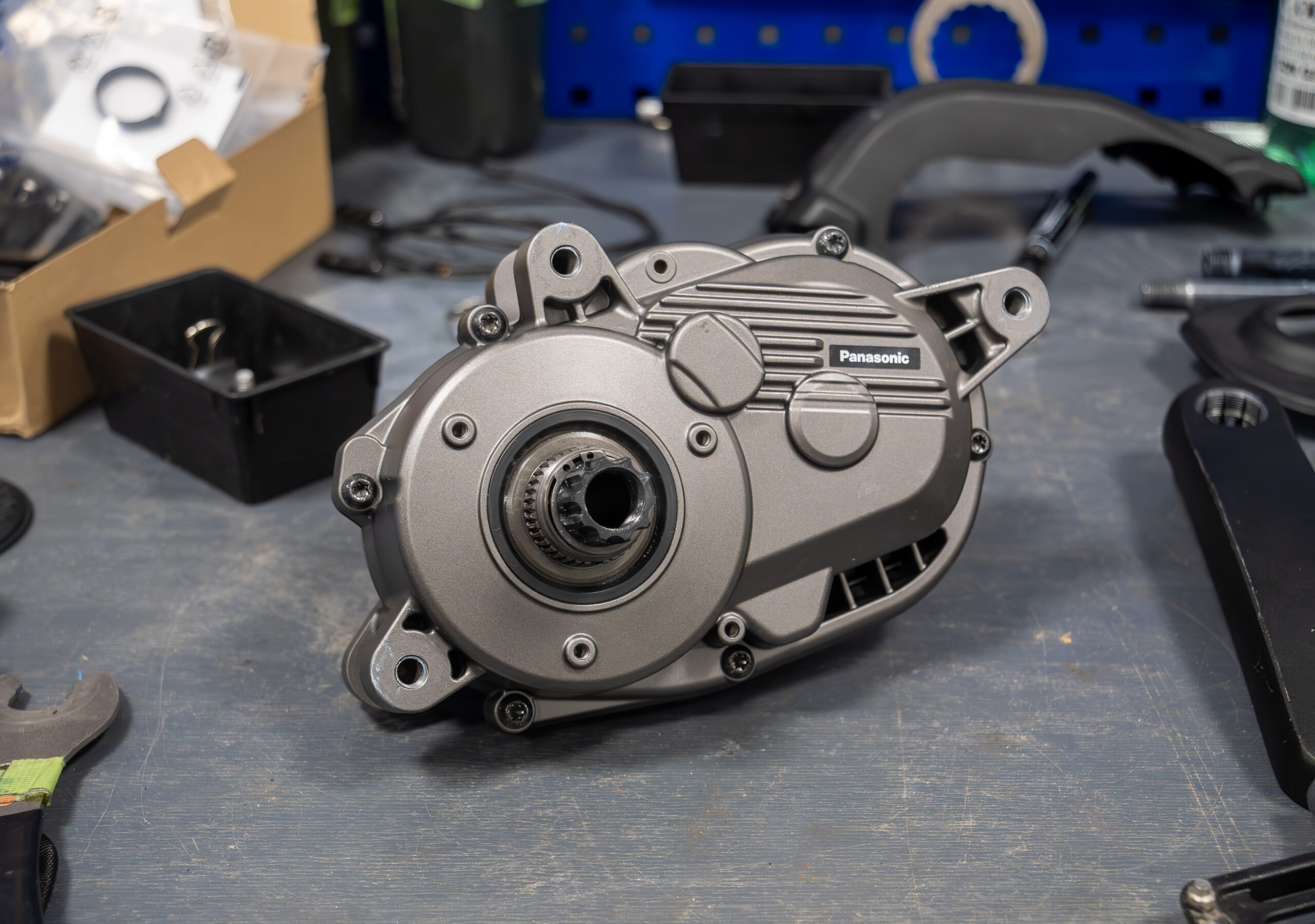 Prototype mid-mounted pedelec motor on a workbench.