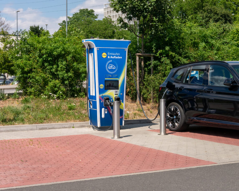 An ABB Terra 360 electric-vehicle charging station at a Lidl car park in Wiesbaden, with a car connected.